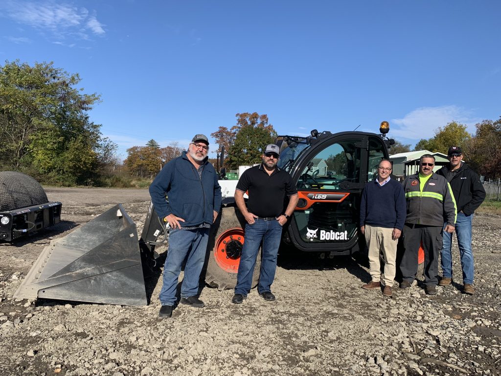 (L-R) Summit Bobcat Branch Manager Dan Morgan, Summit Bobcat Operations Manager Jamie Slaughter, Town of New Paltz Supervisor Neil Bettez, New Paltz Waste Reduction Specialist Mike York, Summit Bobcat Sales Representative Lorenzo D’Angelico stand in front of the town’s new Bobcat TL619 telehandler.